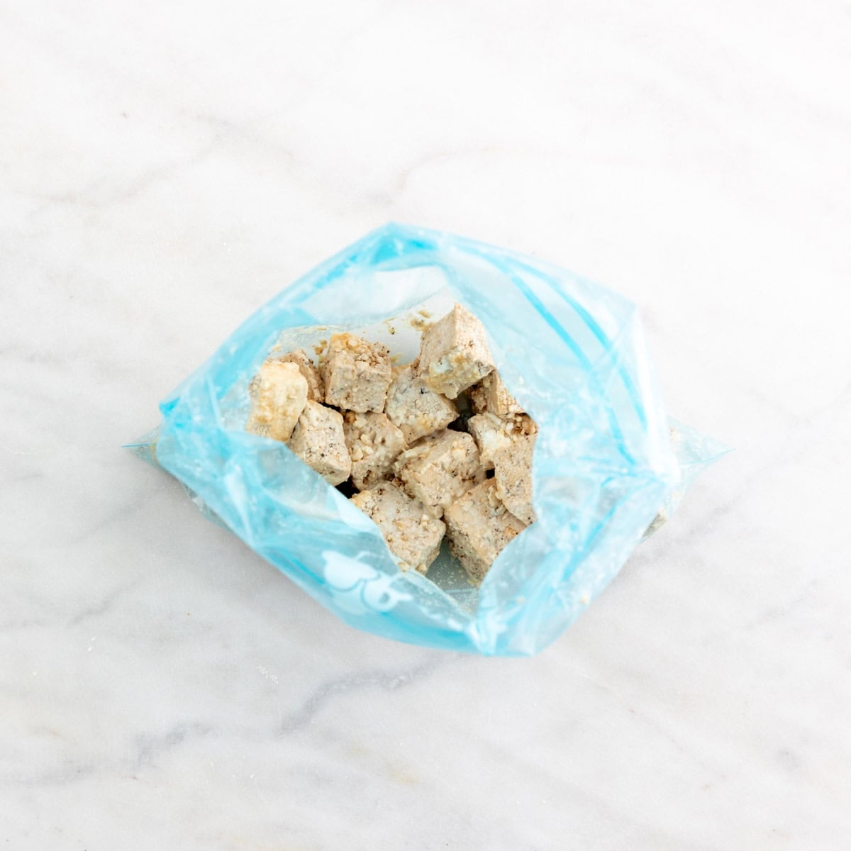 Tofu cubes coated with cornstarch.