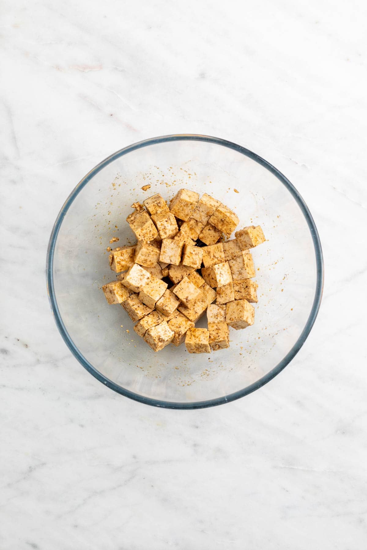 Tofu cubes seasoned in a bowl.