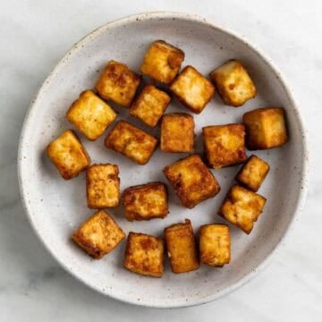 Pan fried tofu cubes with a golden crust.