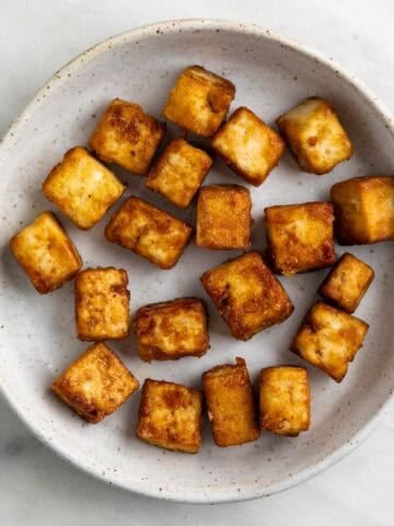 Pan fried tofu cubes with a golden crust.