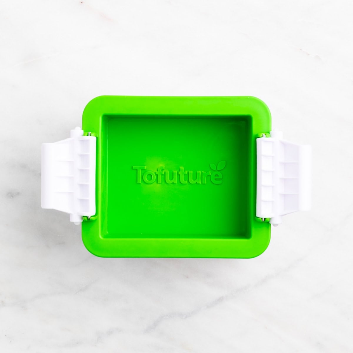 Tofu pressing in a closed tofu press.