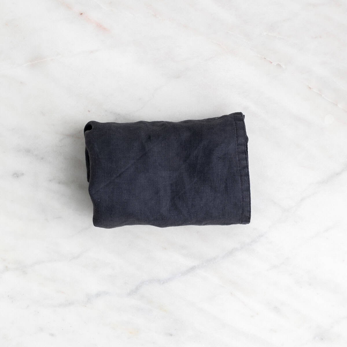 Tofu block wrapped in a kitchen towel to press.