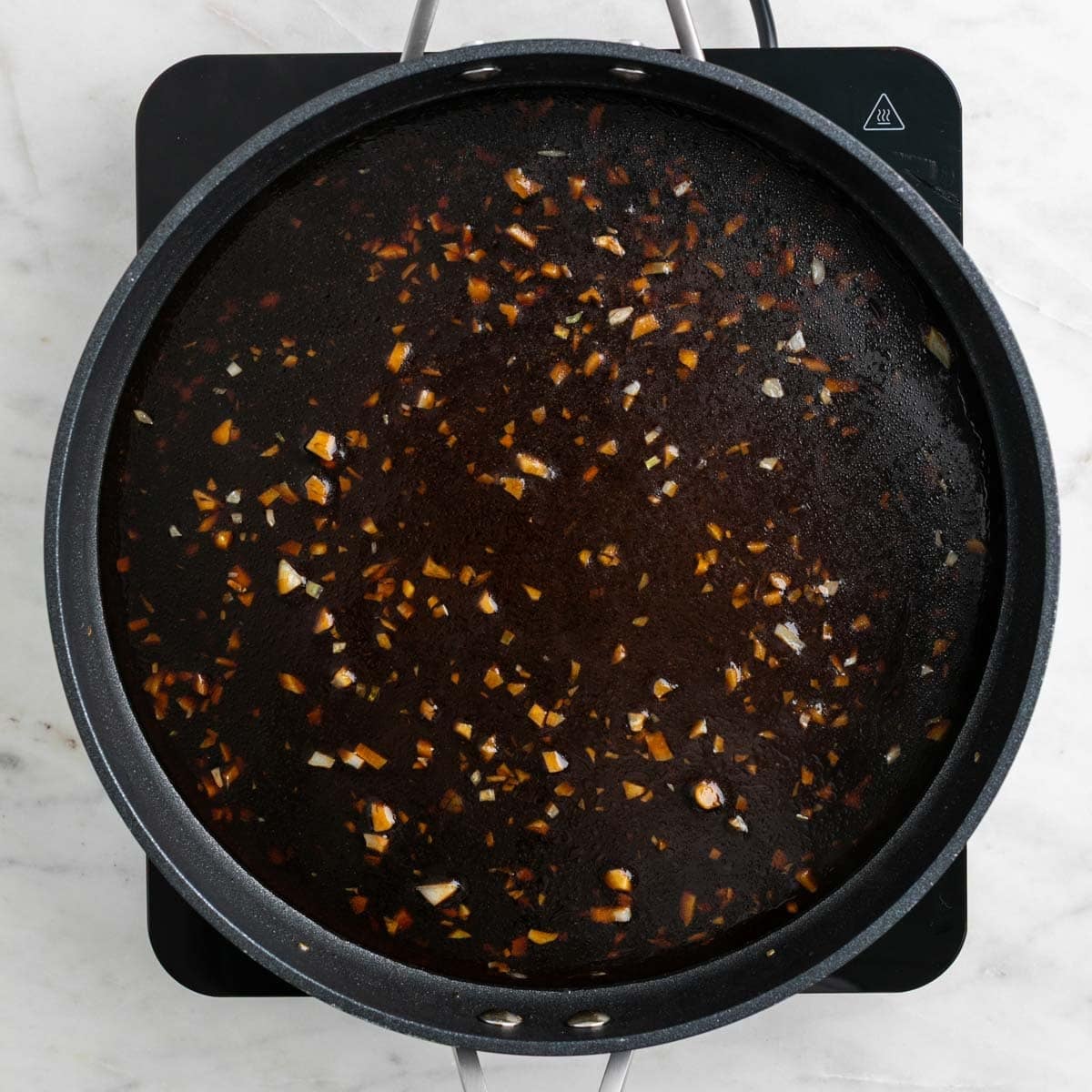 Mongolian sauce cooking in a skillet.