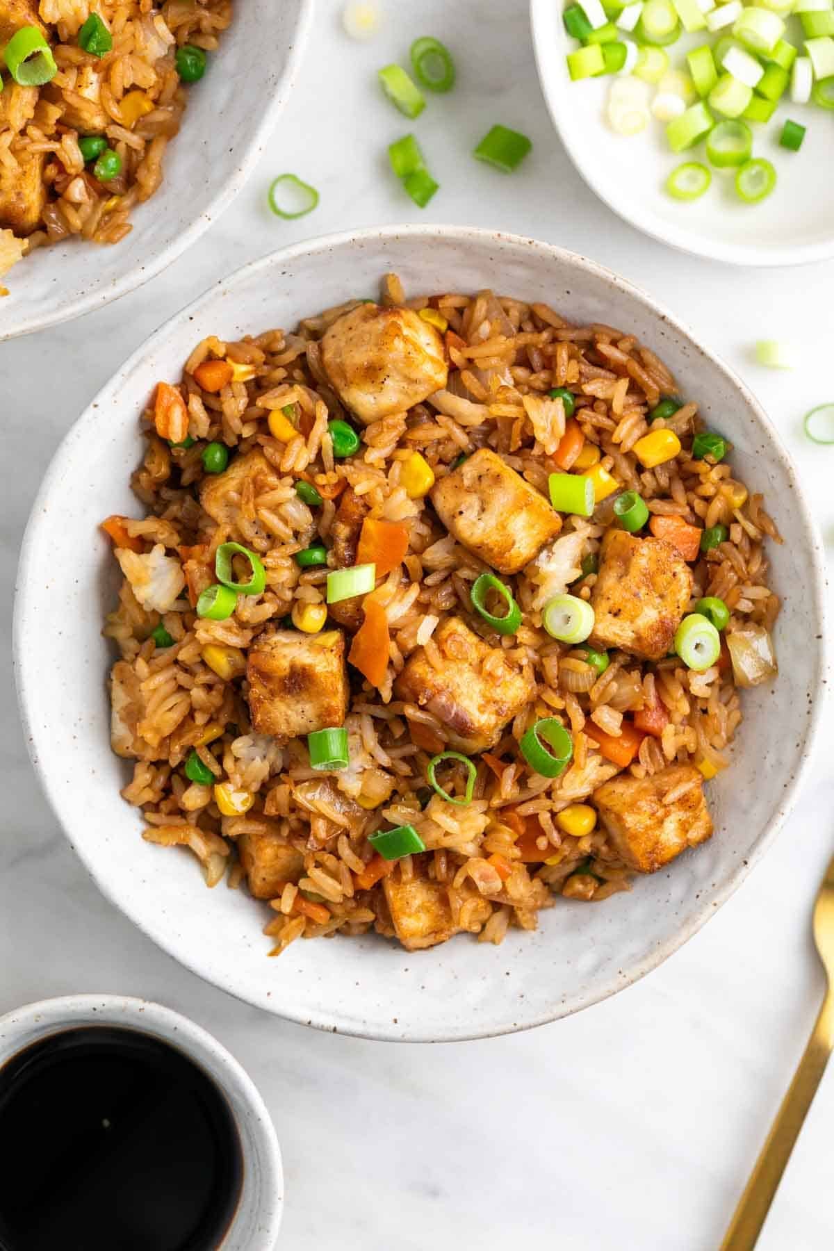 Asian-style tofu fried rice served in bowls.