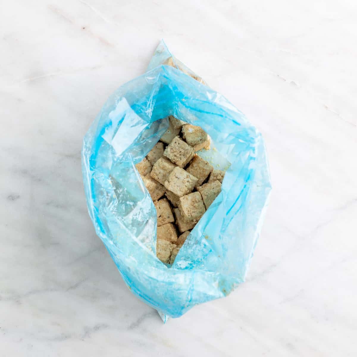 Tofu cubes coated with cornstarch.