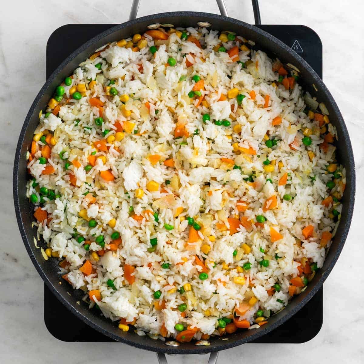 Cold rice added to the skillet.