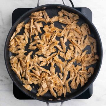 Saut&eacute;ed vegan chicken in a skillet.