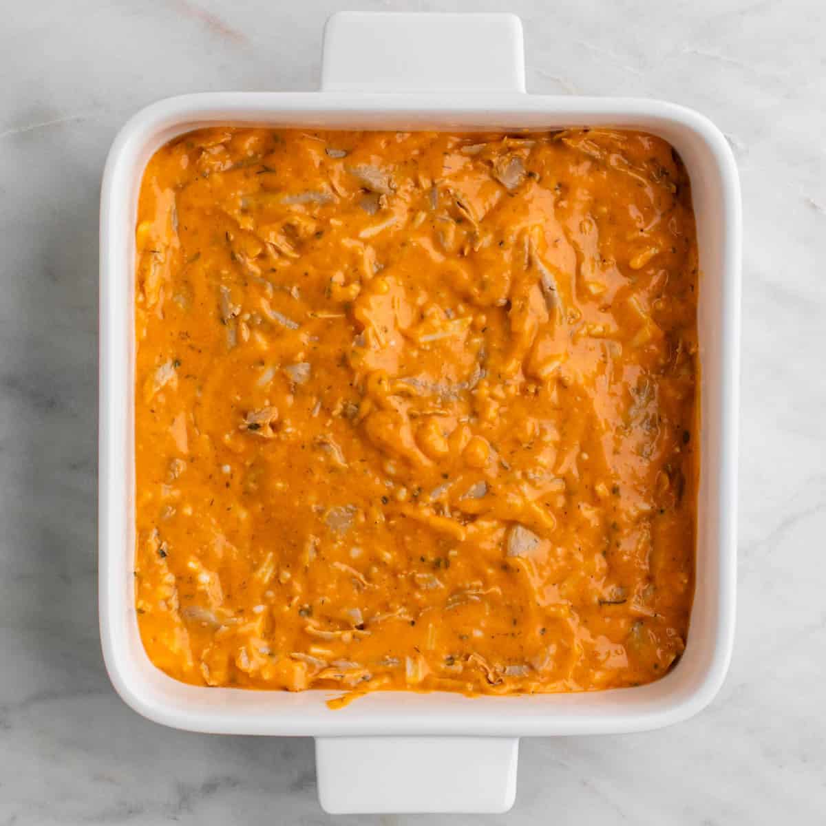 Vegan buffalo chicken dip mixture in a baking dish.
