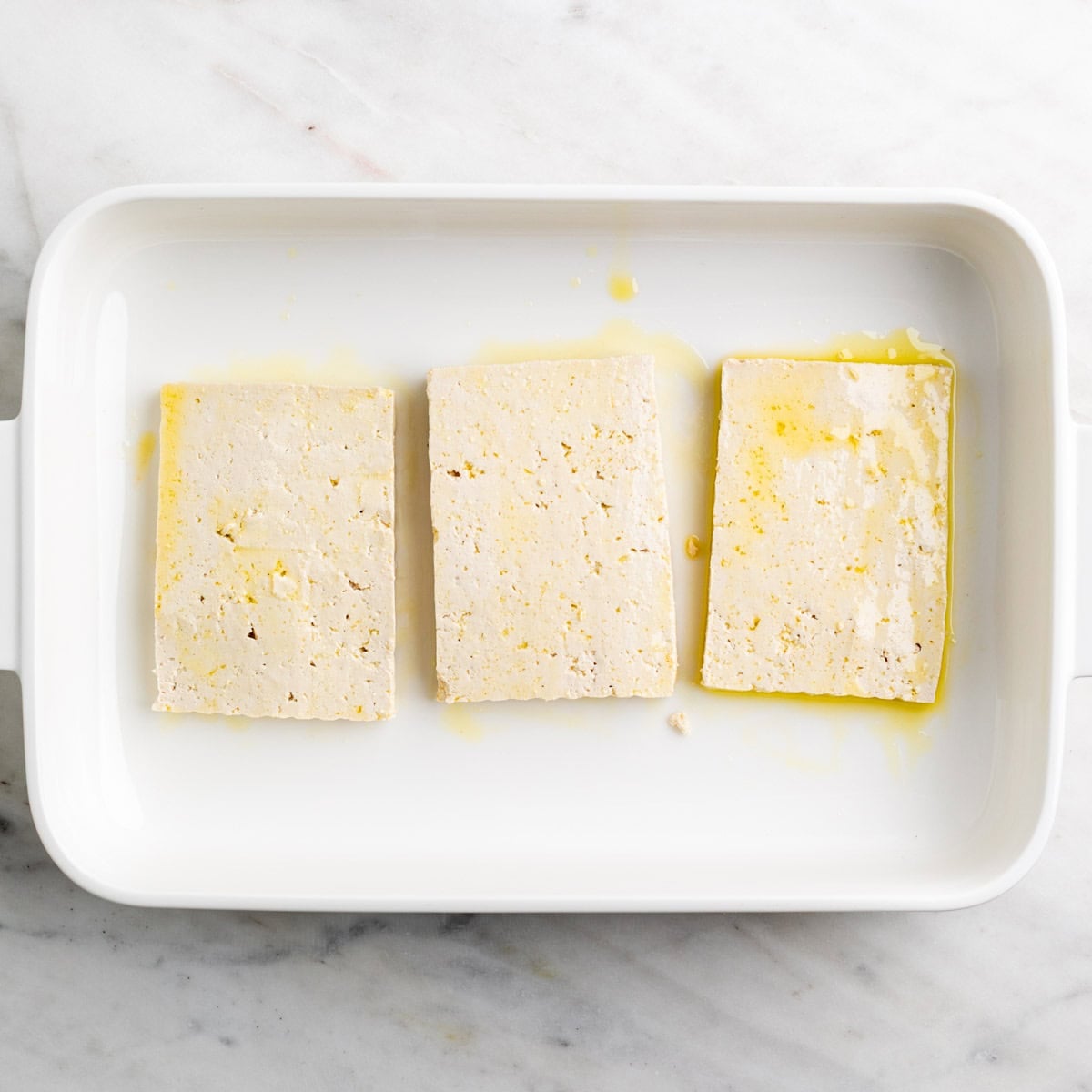 Tofu slabs brushed with olive oil on both sides.