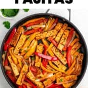 Tofu fajitas cooking in a pan with fresh cilantro garnish
