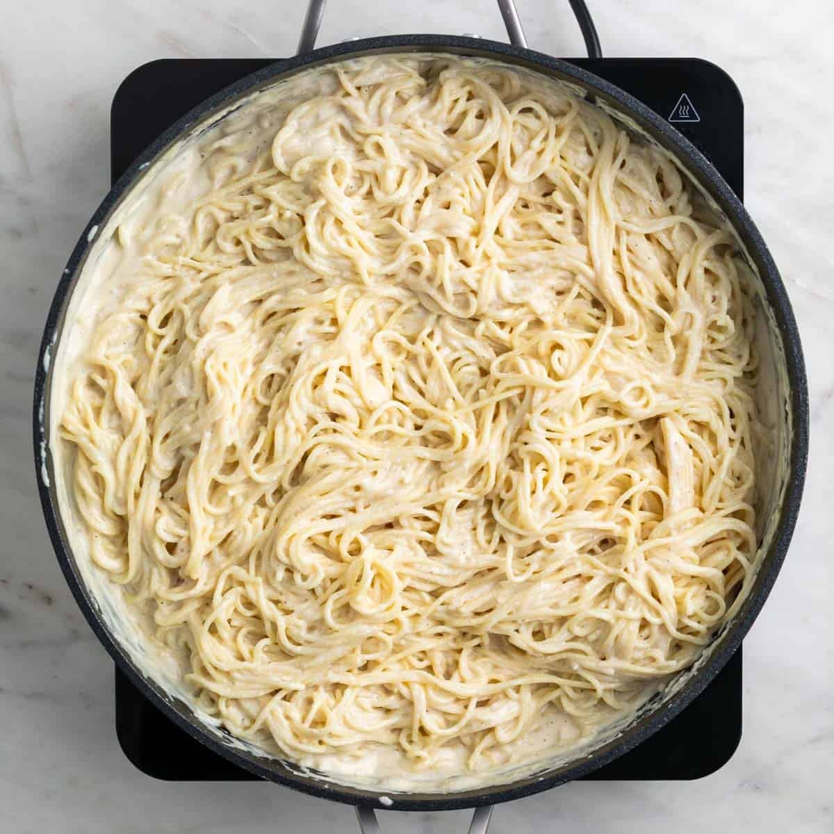 Pasta and sauce mixed together in a skillet