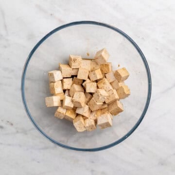 Tofu cubes in a bowl with soy sauce and vinegar
