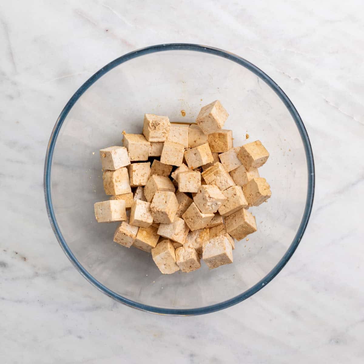 Tofu cubes in a bowl with soy sauce and vinegar