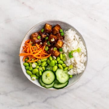 Tofu rice bowl with rice, crispy tofu, and fresh toppings