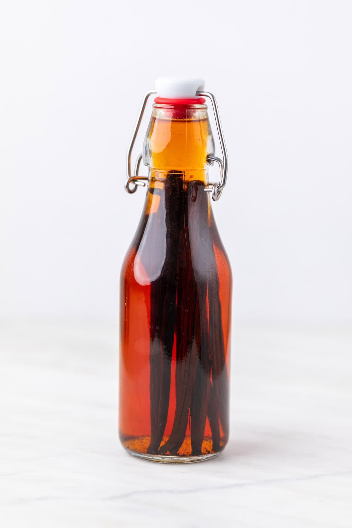 Bottle of homemade vanilla extract after 3 months with vanilla beans inside