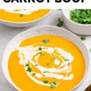 Vegan carrot soup served in bowls with coconut milk drizzle, parsley, and bread