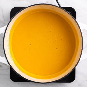 Blended vegan carrot soup in a pot, smooth and creamy