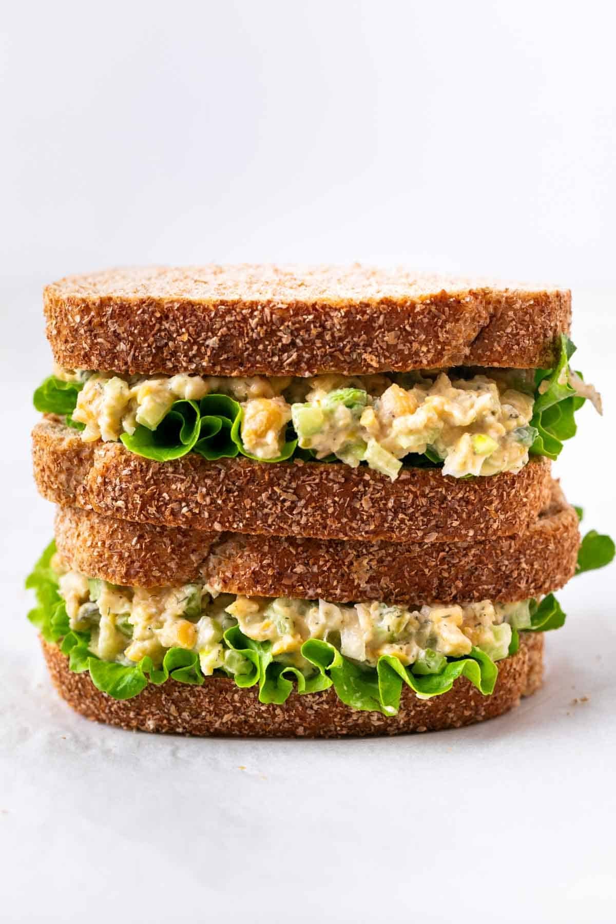 Plant-based chickpea salad sandwich with lettuce, halved and stacked for serving