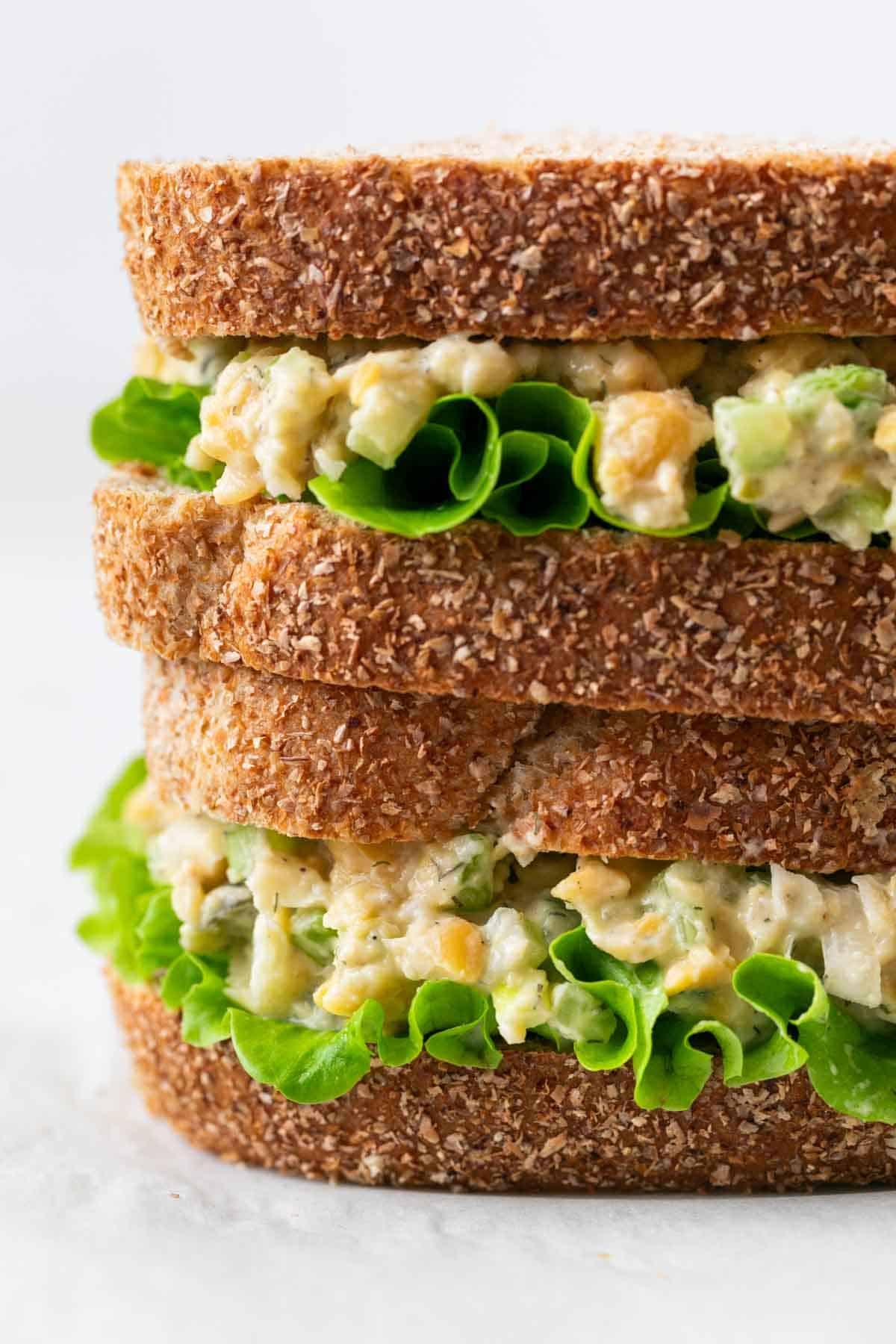 Close-up of chickpea salad sandwich with lettuce, sliced in half