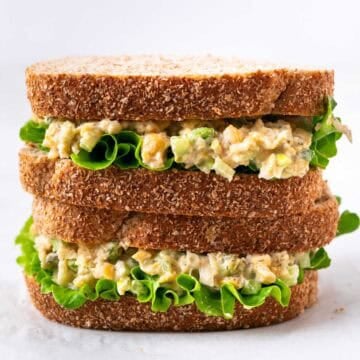 Vegan chickpea salad sandwich with lettuce cut in half and stacked