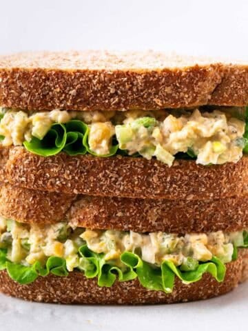 Vegan chickpea salad sandwich with lettuce cut in half and stacked