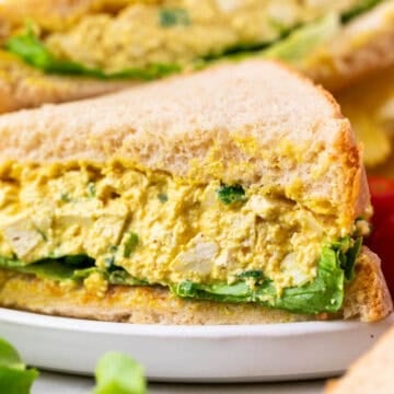 Two vegan egg salad sandwiches on a plate
