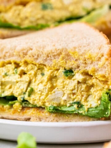 Two vegan egg salad sandwiches on a plate