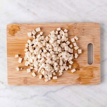Chopped tofu on a cutting board