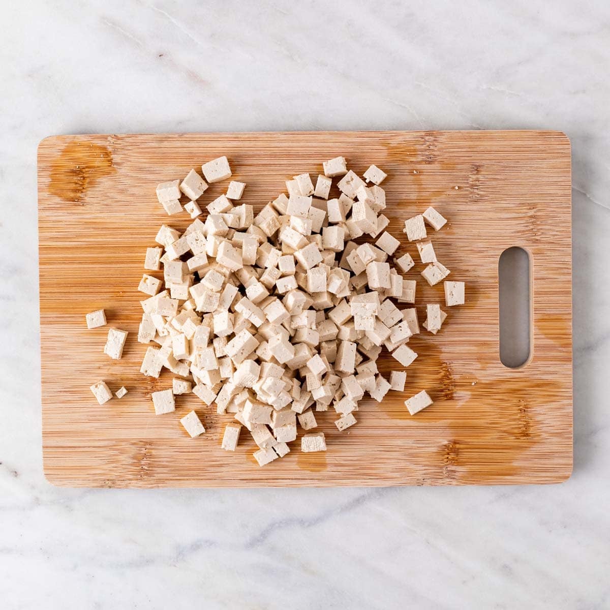 Chopped tofu on a cutting board