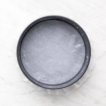 Greased 9-inch cake pan lined with parchment paper