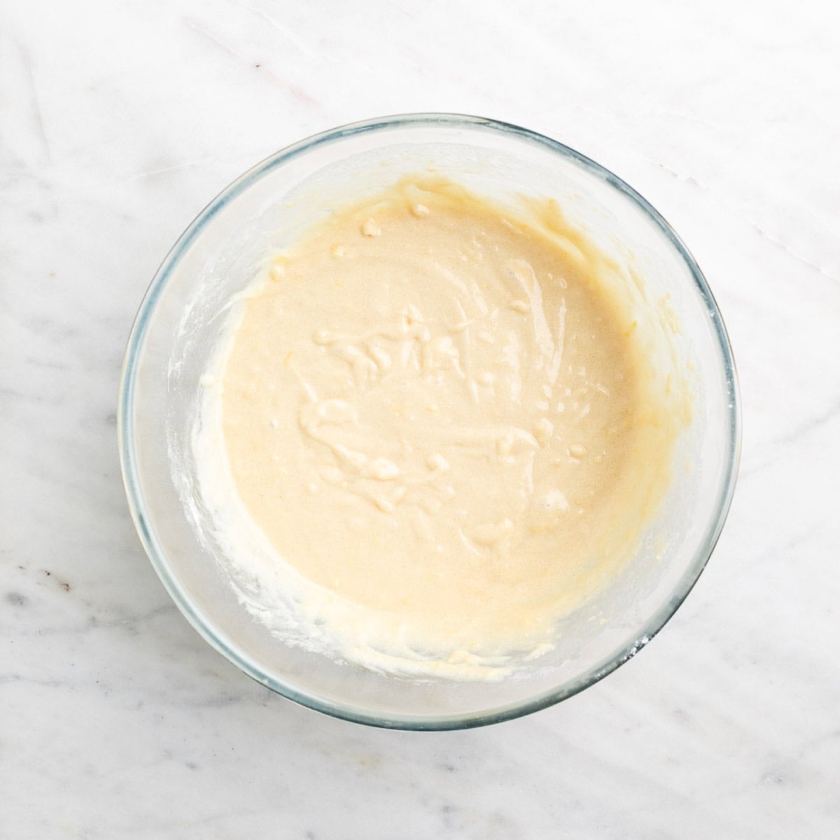 Vegan lemon cake batter in a bowl before adding blueberries
