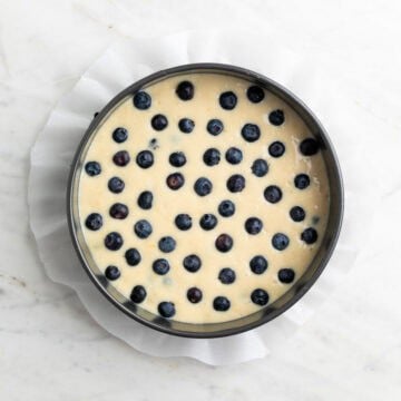 Cake batter with blueberries poured into the baking pan