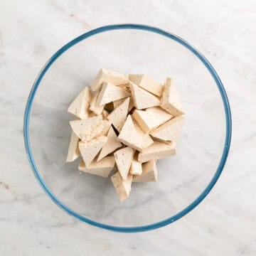 Tofu triangles in a mixing bowl