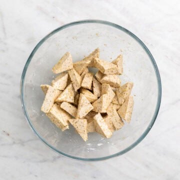 Tofu triangles coated with cornstarch and seasonings