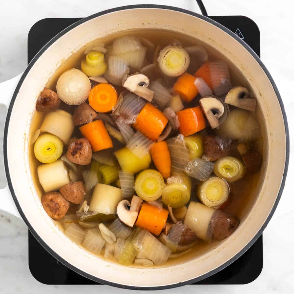 Homemade vegetable broth cooking in a pot