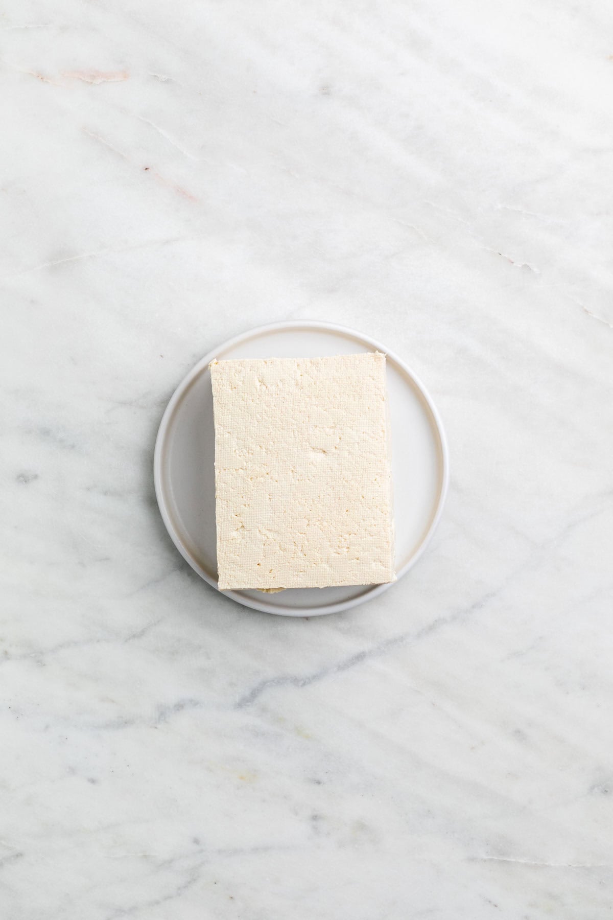 Firm tofu after freezing and thawing on a plate