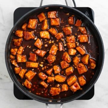 Crispy tofu coated in Korean BBQ sauce in a skillet