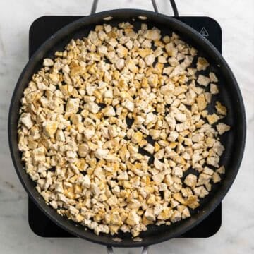 Crumbled tofu cooking in a skillet