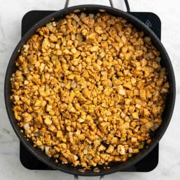 Crumbled tofu with sauce and water chestnuts in a skillet