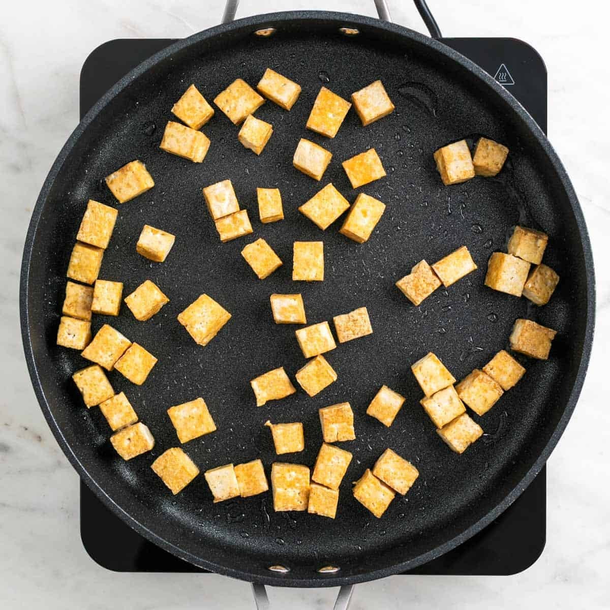 Tofu cooking in a skillet