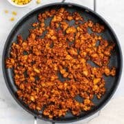 Tofu taco meat in a pan with corn and tortillas ready to serve