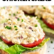 Open-faced vegan chicken salad sandwiches served with lettuce, tomato, chives, and black pepper