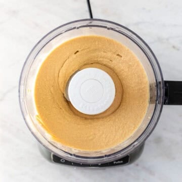 Homemade hummus blended in a food processor until smooth and creamy