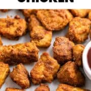 Golden brown tofu chicken with BBQ dipping sauce on a white background