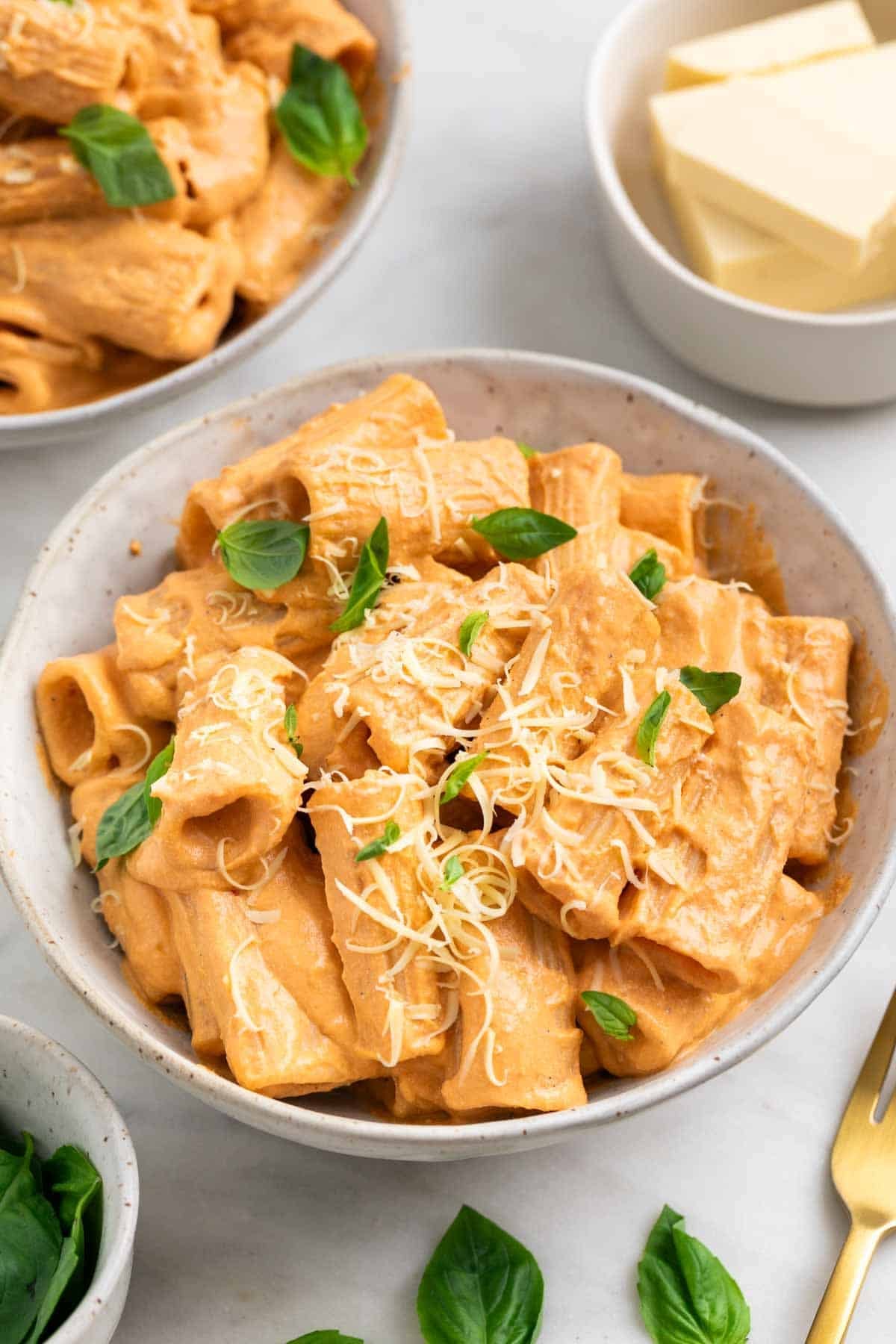 Tofu pasta with creamy tomato sauce, basil, and vegan Parmesan
