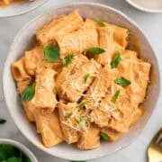 Easy tofu pasta served with vegan Parmesan and fresh basil