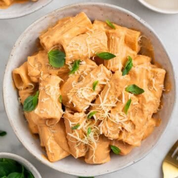 Easy tofu pasta served with vegan Parmesan and fresh basil