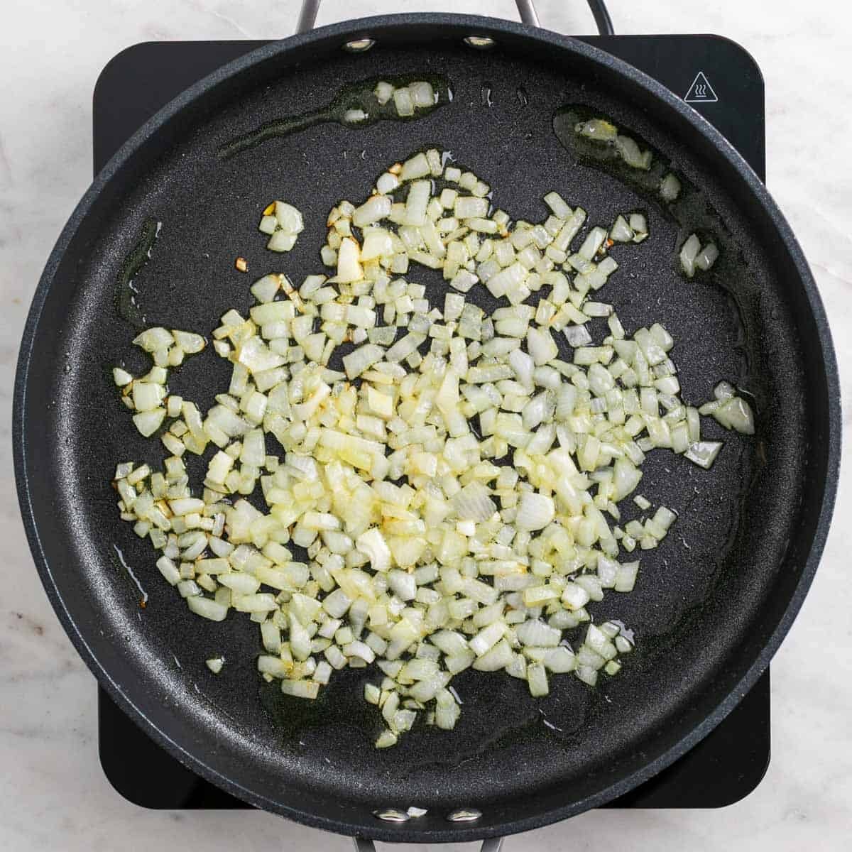 Onion cooking in olive oil in a large skillet