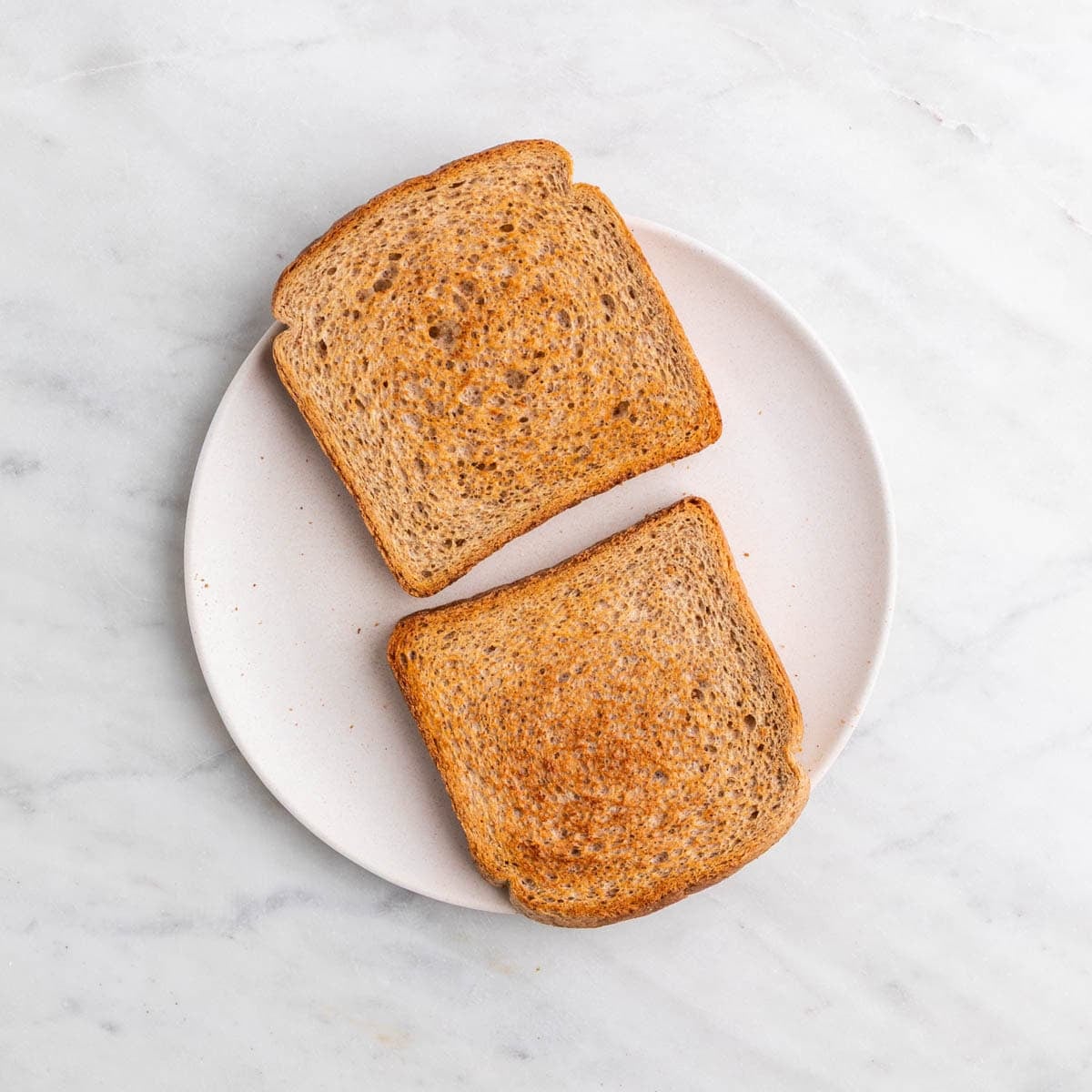 Two slices of bread toasted until lightly golden