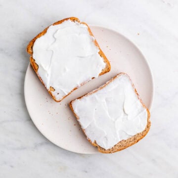 Vegan mayonnaise spread over one side of each toast slice